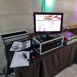 Karaokespelare med mikrofoner, låtlista, monitor och mixerbord.